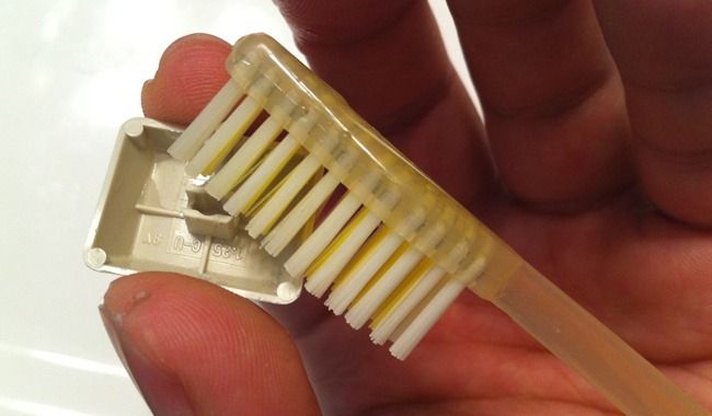 Use a tooth brush to clean the underside of a key