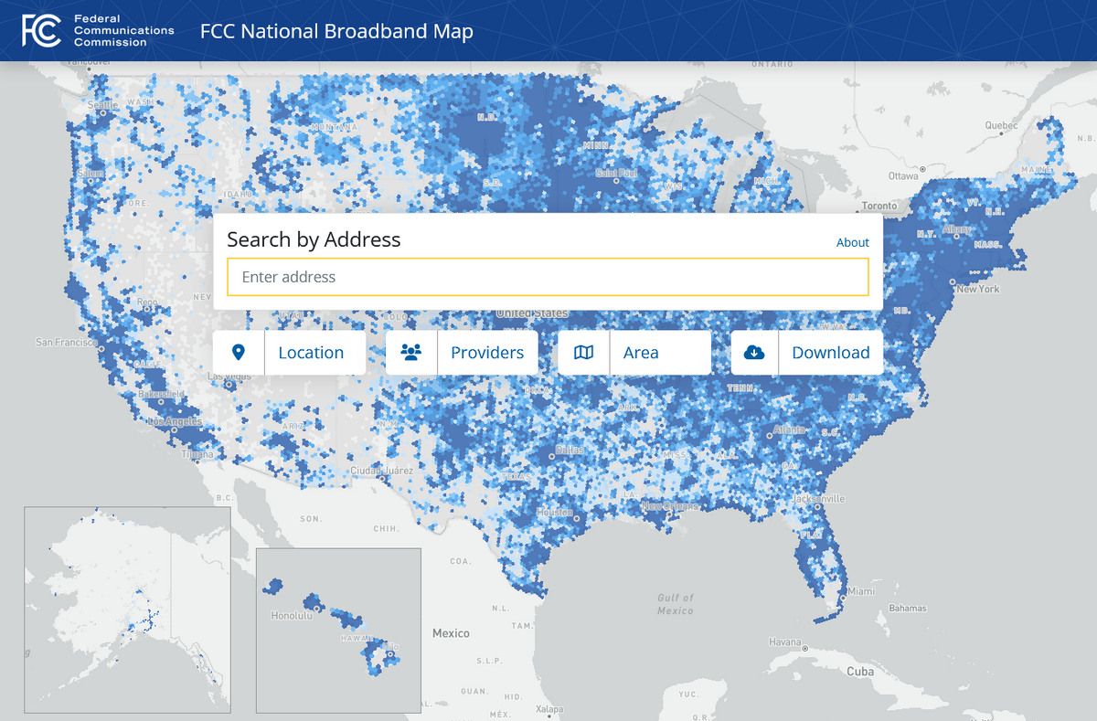 A screenshot of the FCC's National Broadband Map showing a pattern of blue dots across the United States indicating broadband saturation.