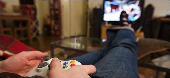 An image of a person with their feet up playing a video game.