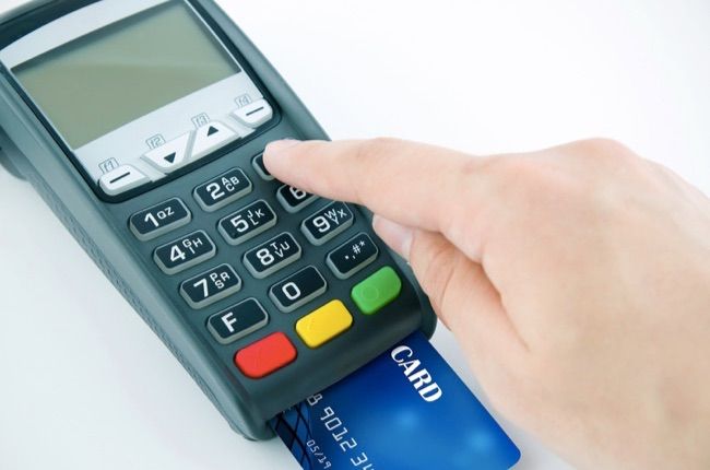 Man using payment terminal keypad enter personal identyfication number