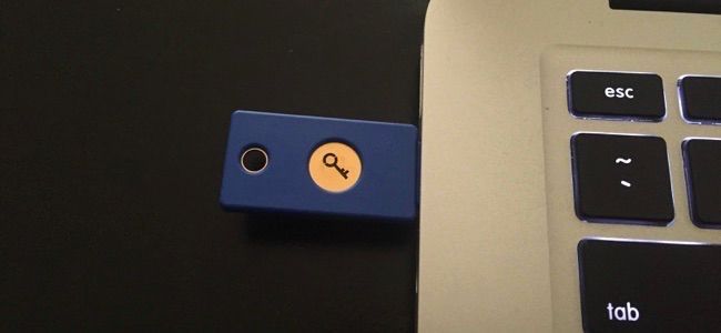 A Yubikey physical USB security key plugged into the USB port on a laptop.