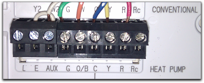 A typical low-voltage thermostat, with multiple small wires in different colors.