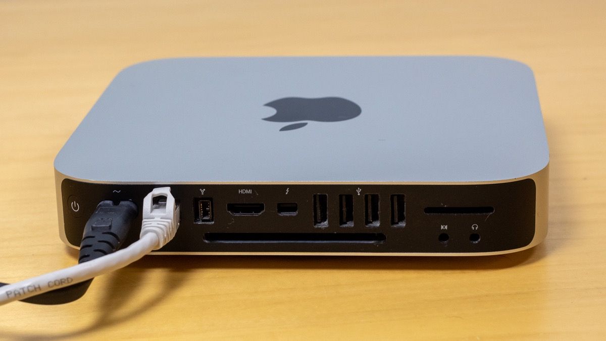 Power and ethernet cable plugged into the back of an Apple Mac Mini