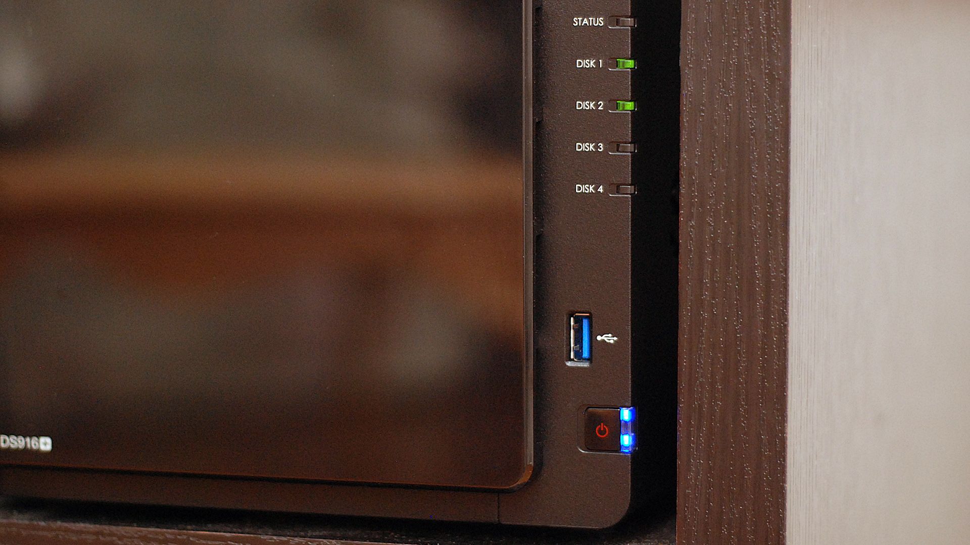 A closeup of the power button on a Synology NAS.