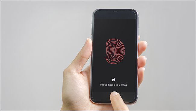 A person using Touch ID on an iPhone.
