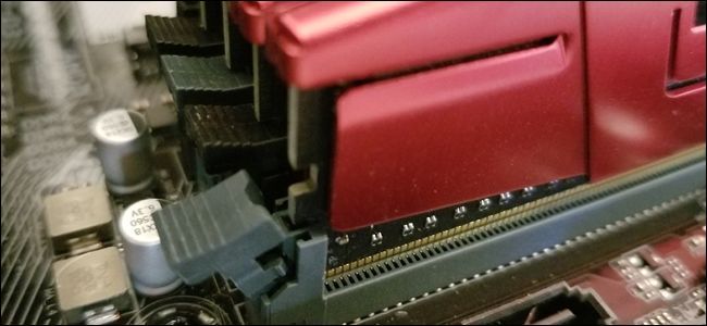 A tab on a RAM slot not locked into place on the RAM stick. 