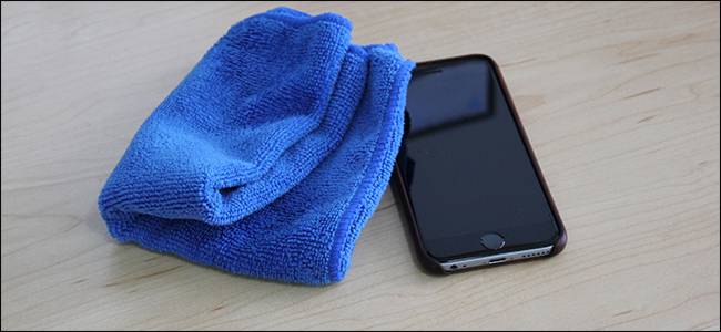 A blue microfiber cloth sitting next to an iPhone. 