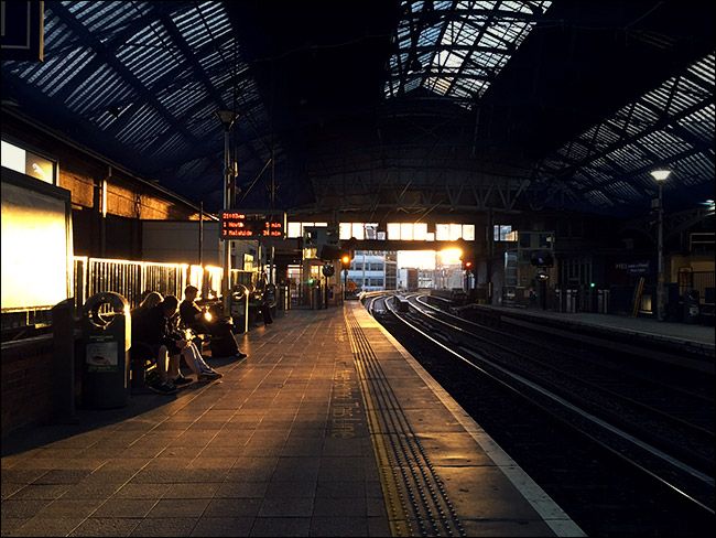 interior of train station with sun setting in background