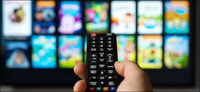 Hand pointing a remote at a smart TV