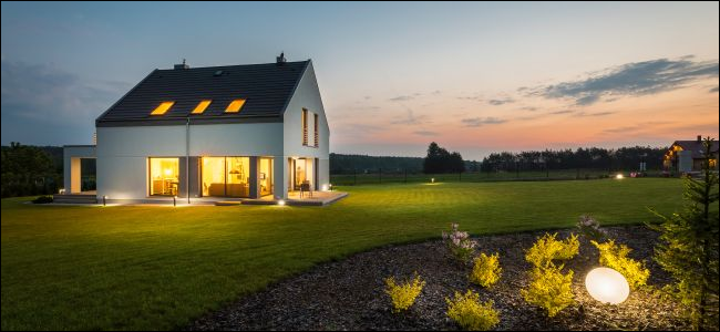 Modern rural home with outdoor lighting at night