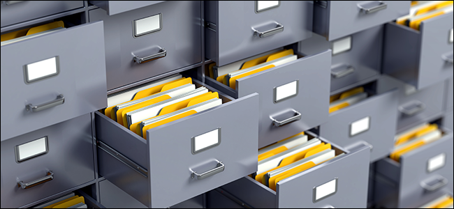 abstract filing cabinets bulging with files