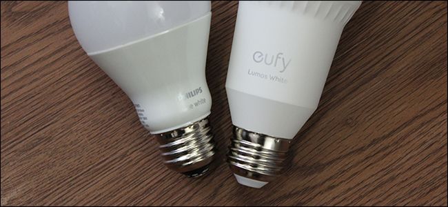 A Philips and Eufy smart bulb side by side.