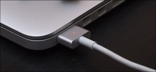 MacBook charging with orange light on cable