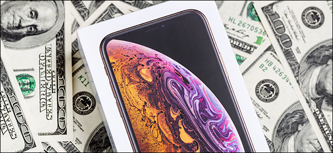 An iPhone X case on a pile of money