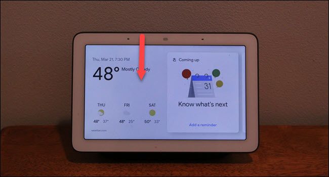 Google Home hub with down arrow drawn from top of the screen.