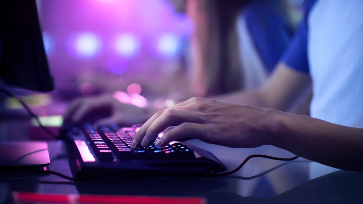 Gamer's hands on a PC keyboard