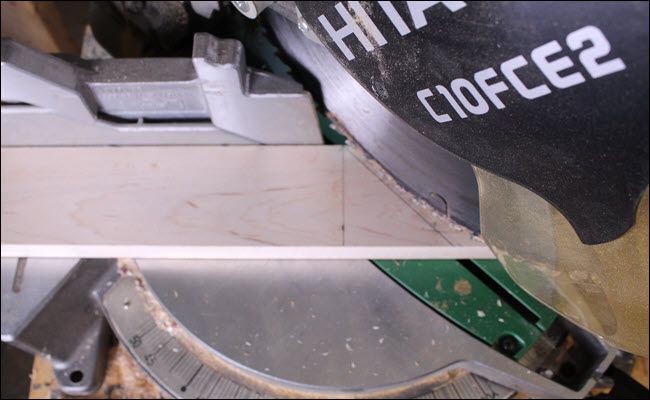 Board on a miter saw with a 90 degree line a 45 degree line