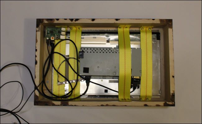 Frame box with strapped monitor and glass and raspberry pi