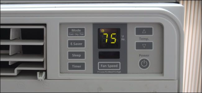 A closeup of an A/C unit showing an electrical switch and LED screen.