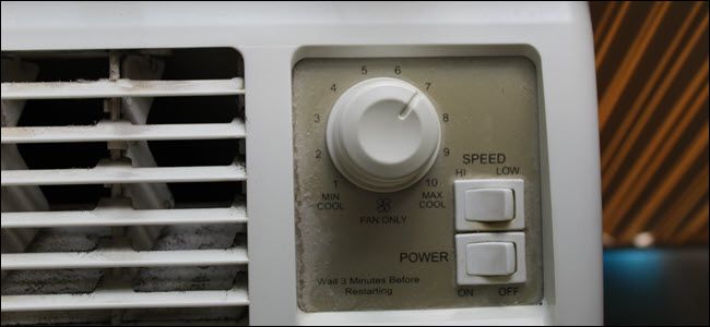 Closeup of A/C unit showing mechanical power and speed switches and a turn dial.
