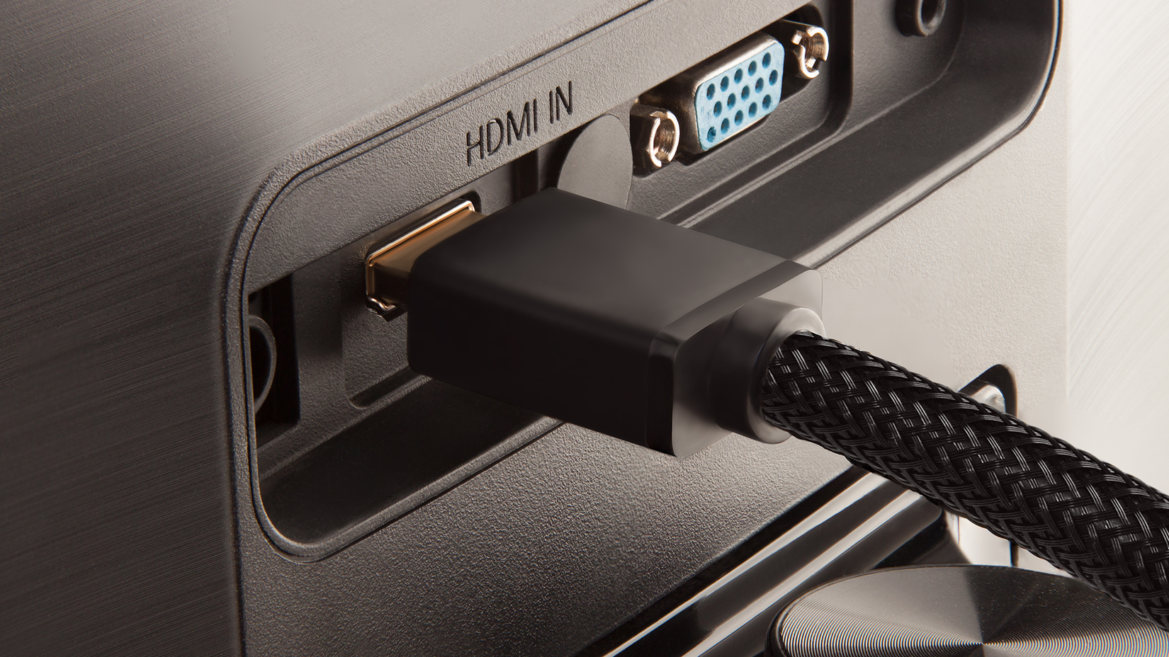 An HDMI cable plugged into the back of a TV