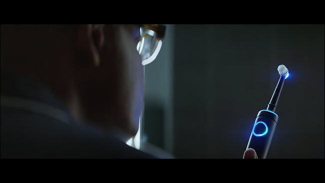 Man from Alexa commercial staring at his lit-up Echo toothbrush.