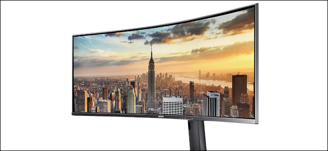 A Samsung43-inch ultrawide monitor showing a New York skyline scene at sunset.