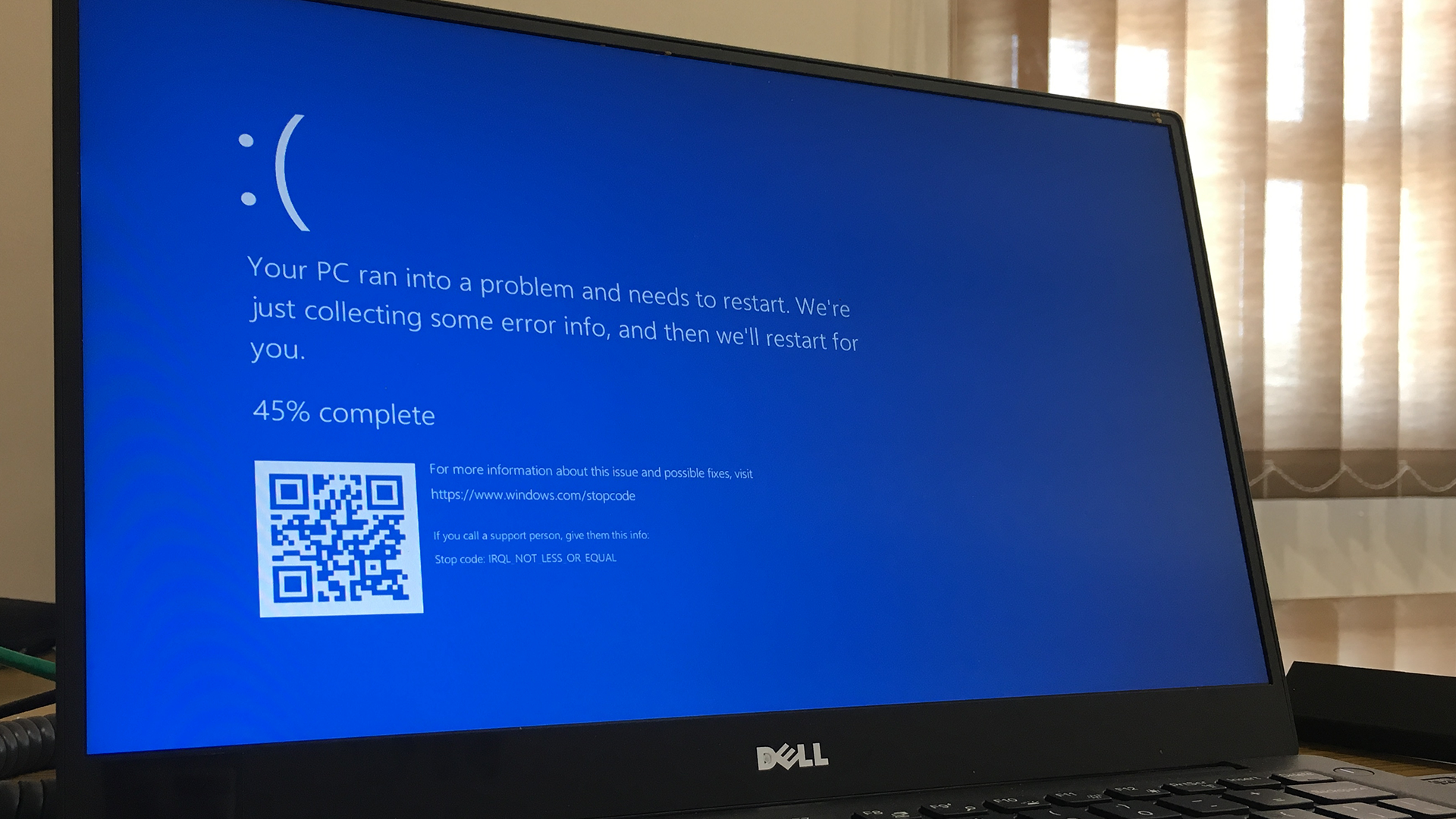 A Windows PC displays a blue screen and error message with a frowny face.