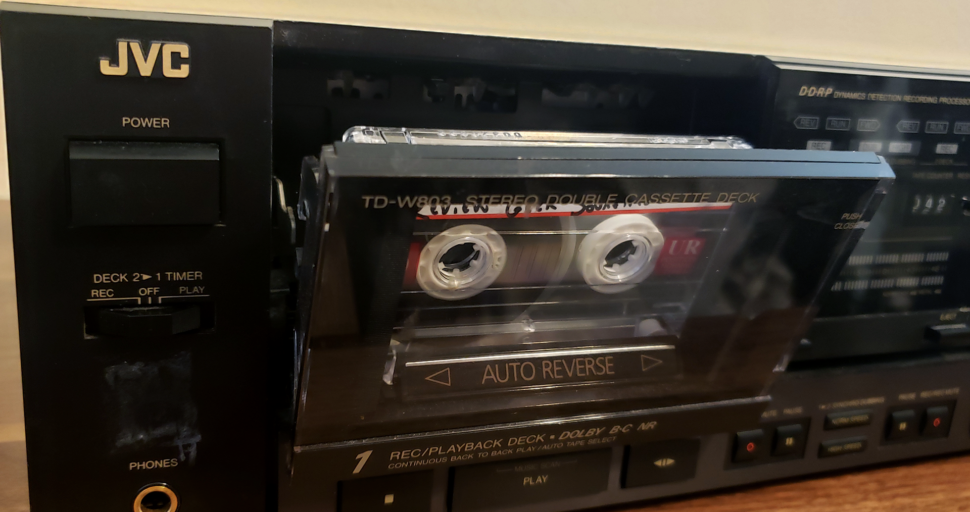 The Review Geek soundtrack cassette tape in a JVC tape deck.