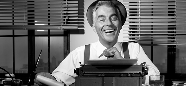 An old-timey reporter laughs behind a typewriter.