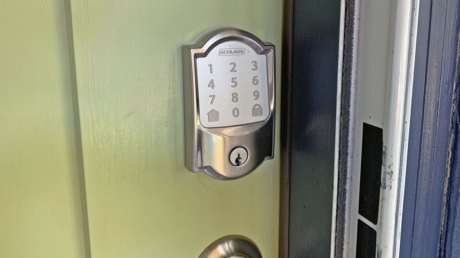 A Schlage Encode lock on a green door