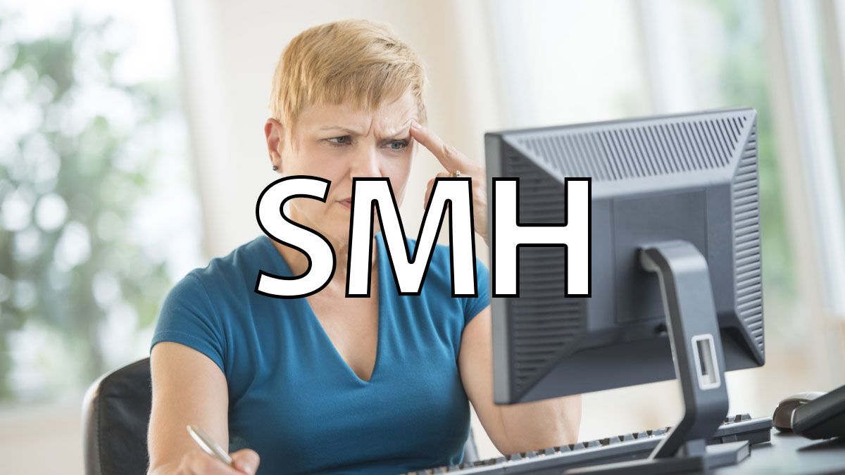 A woman looks confused at her computer