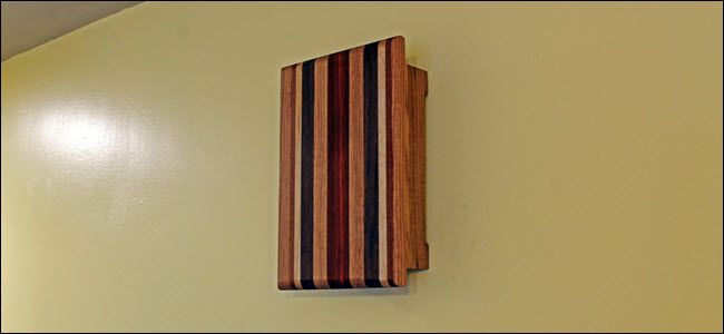 A Wooden chime box near a ceiling.