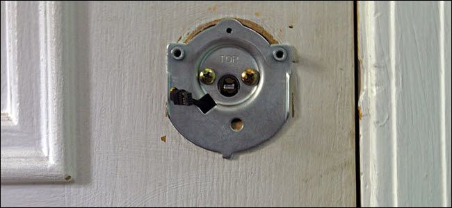 A metal plate with two screws and a power wire sticking through it.