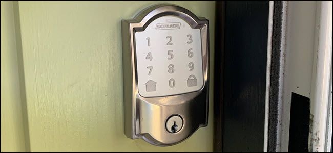 A Schlage Encode Wi-Fi lock on a green door.