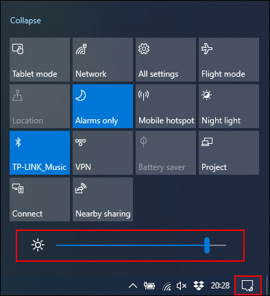 Tap the Action Center icon in your Windows taskbar, then move your brightness slider towards the left