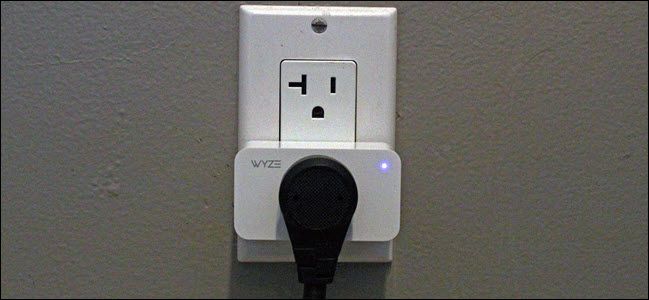 A Wyze plug in an outlet with a plug connected to it.