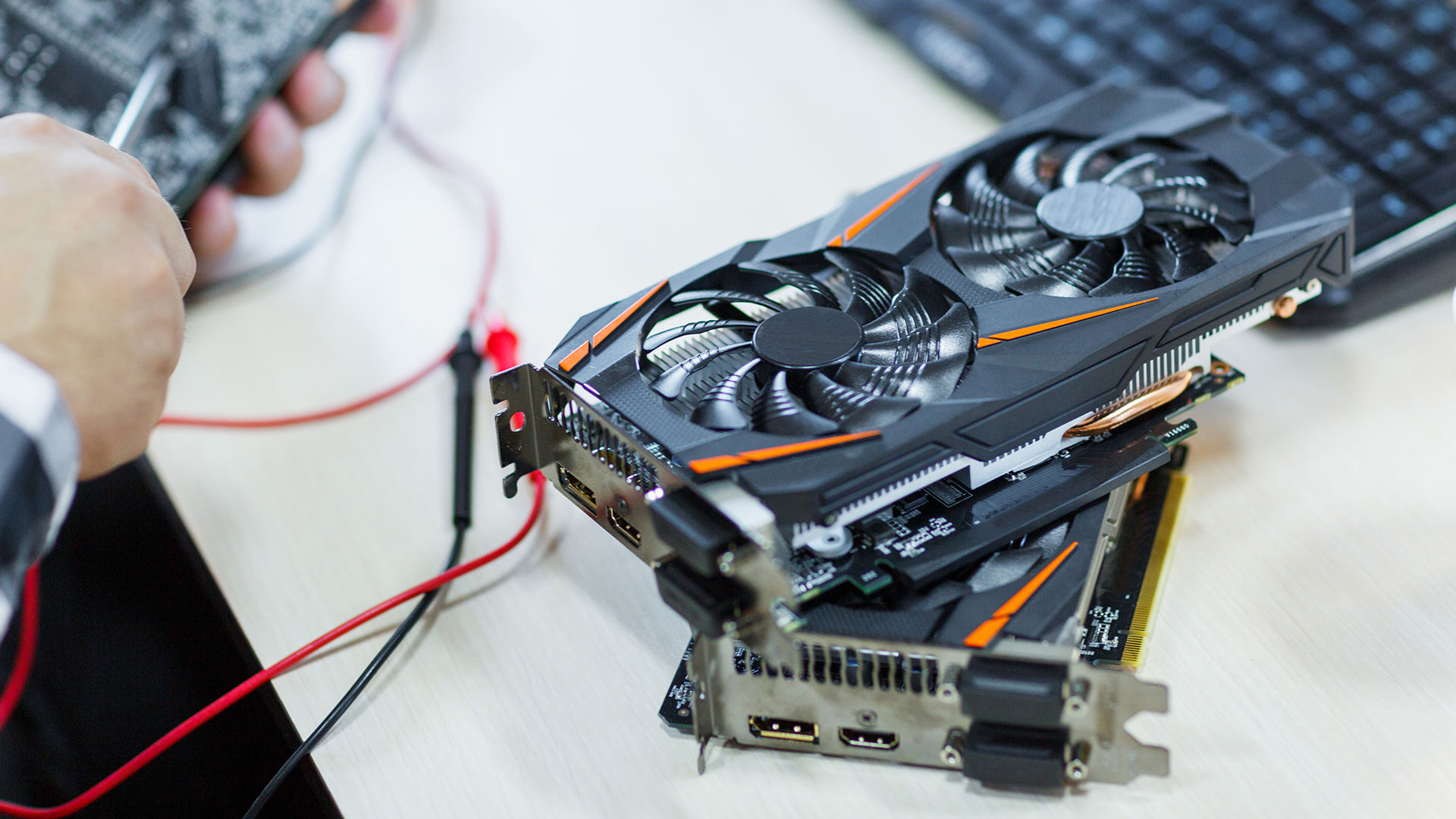 A photo of two graphics cards stacked on top of one another for testing.
