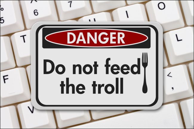 A &quot;Danger: Do not feed the troll&quot; sign on a computer keyboard.