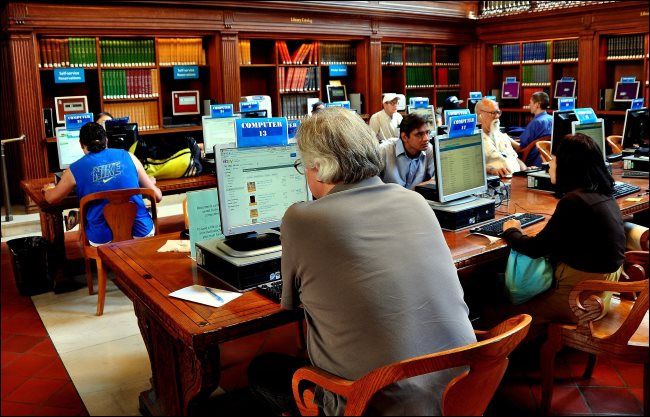 People using public computers in a New York City library