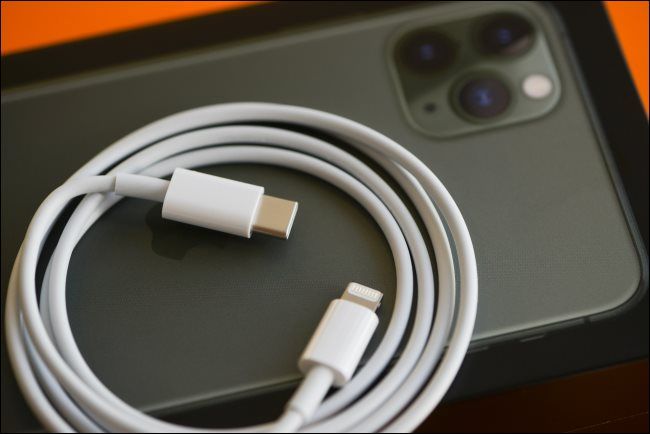 A Lightning-to-USB-C fast-charging cable resting on an iPhone 11.