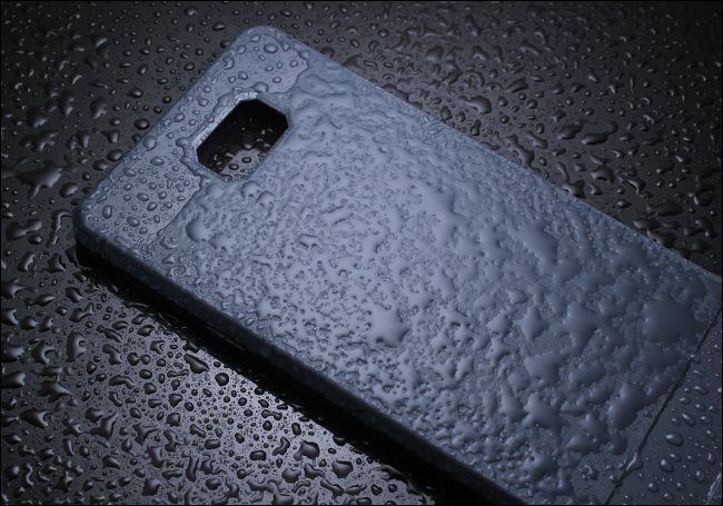 A smartphone case covered in water.