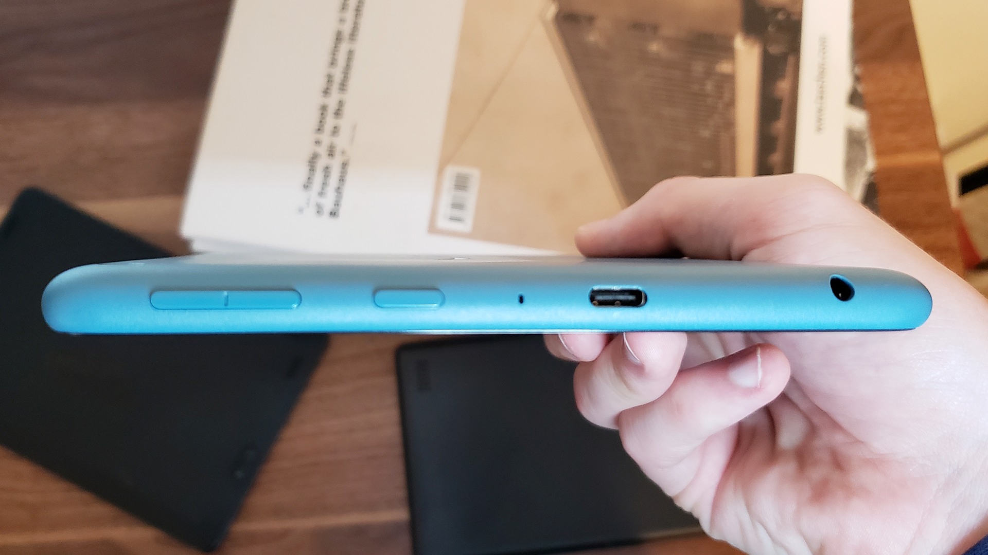 A photo of the Fire HD 8's USB-C port, aux port, volume controls and power button.