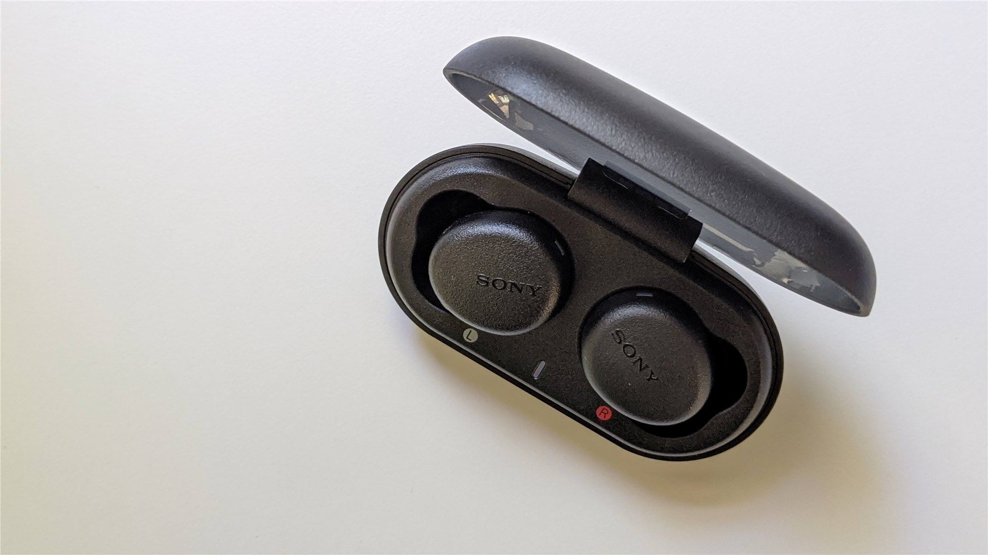 A top down view of the Extra Bass earbuds with the case open