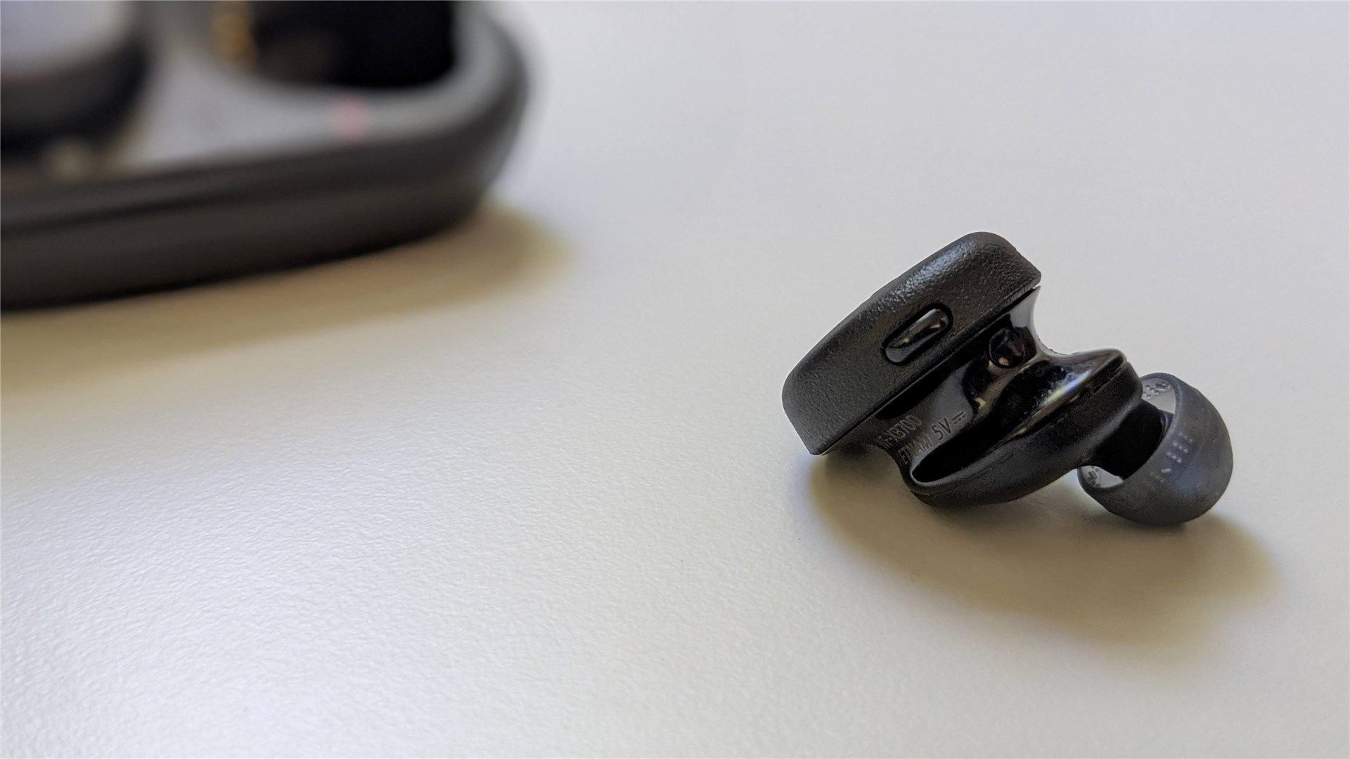 Showing the button on the right Sony Extra Bass earbuds