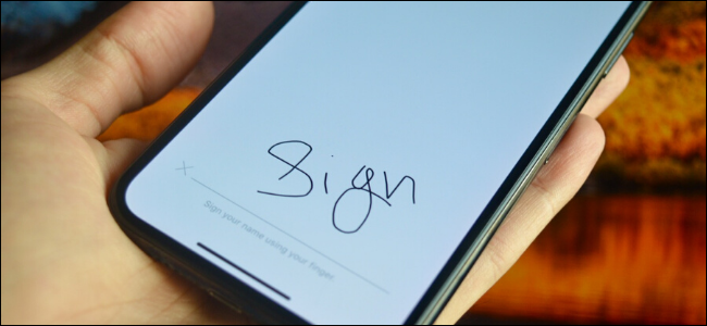 iPhone user signing a document using their finger