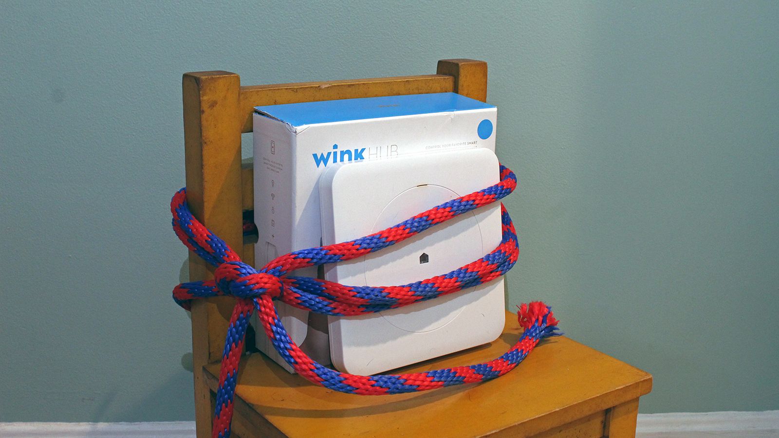 A Wink Hub tied up to a chair.