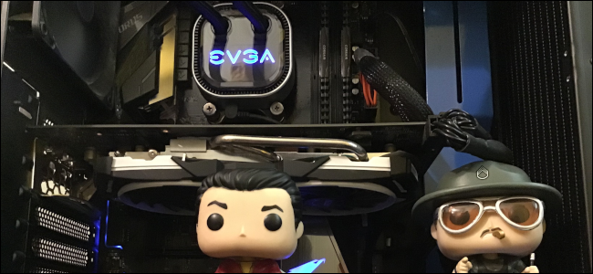 The inside of a desktop PC with two Funko Pop dolls inside the case.