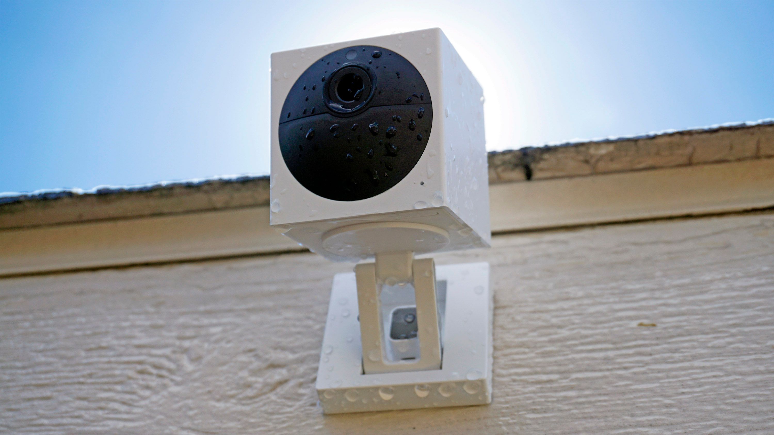 Wyze Cam Outdoor, mounted to the wall, covered in drops of water