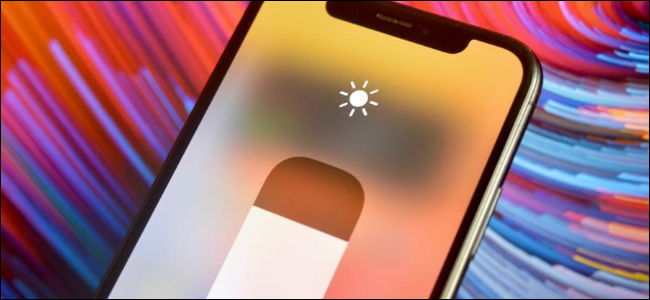 iPhone user adjusting brightness on their device